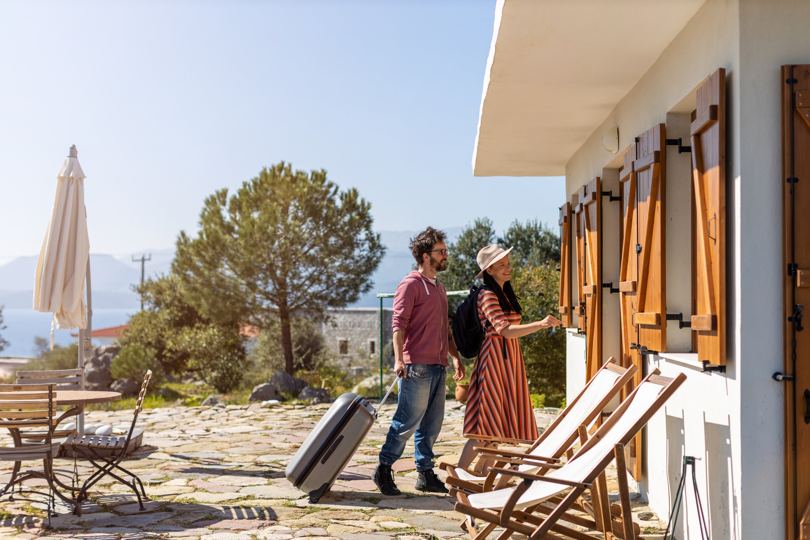 Young couple arriving to at holiday home